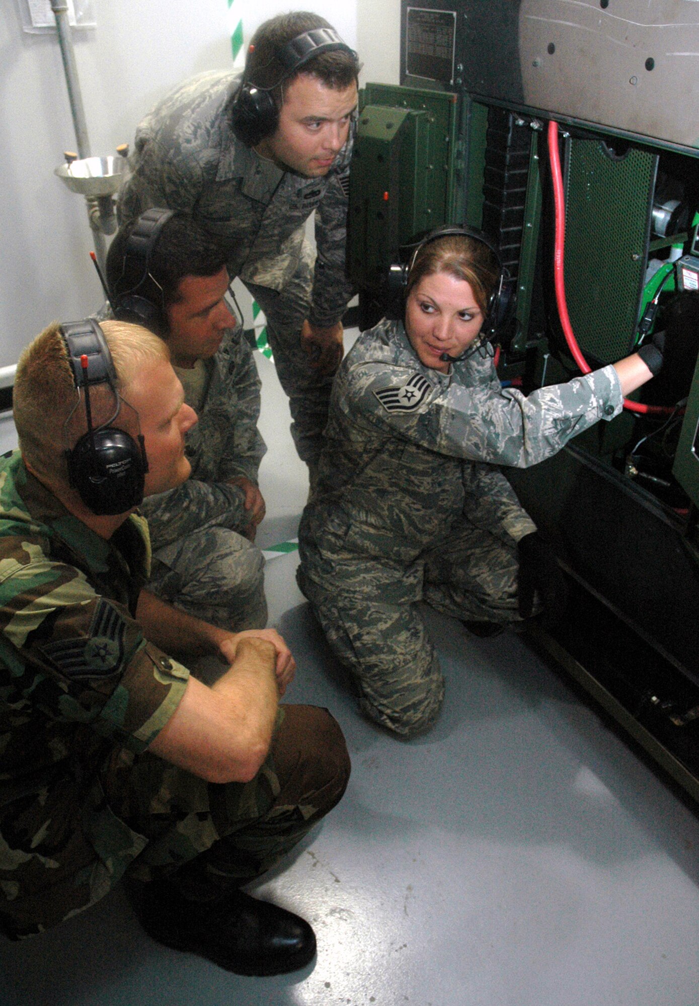 Staff Sgt. Jamie Widrig (right), instructor and course director for the Mobile Command and Control Generator Course for the U.S. Air Force Expeditionary Center's Mobility Operations School at Fort Dix, N.J., shows students in her course the basics for a generator June 5, 2008, at the Center.  Annually, the USAF EC trains more than 23,000 students in expeditionary- and mobility air force-based course both with in-residence and distance learning.  (U.S. Air Force Photo/Tech. Sgt. Scott T. Sturkol)