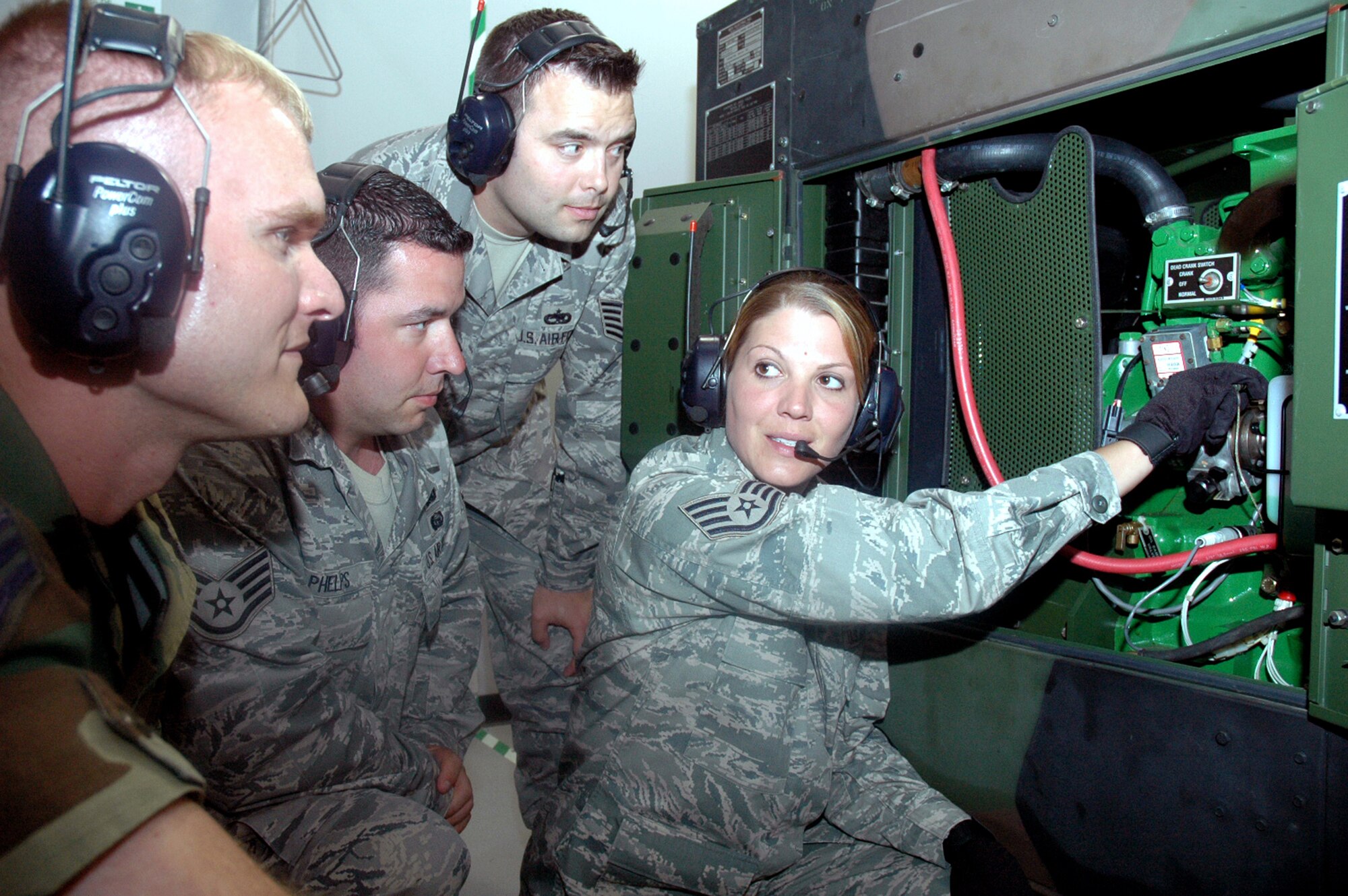 Staff Sgt. Jamie Widrig (right), instructor and course director for the Mobile Command and Control Generator Course for the U.S. Air Force Expeditionary Center's Mobility Operations School at Fort Dix, N.J., shows students in her course the basics for a generator June 5, 2008, at the Center.  Annually, the USAF EC trains more than 23,000 students in expeditionary- and mobility air force-based course both with in-residence and distance learning.  (U.S. Air Force Photo/Tech. Sgt. Scott T. Sturkol)