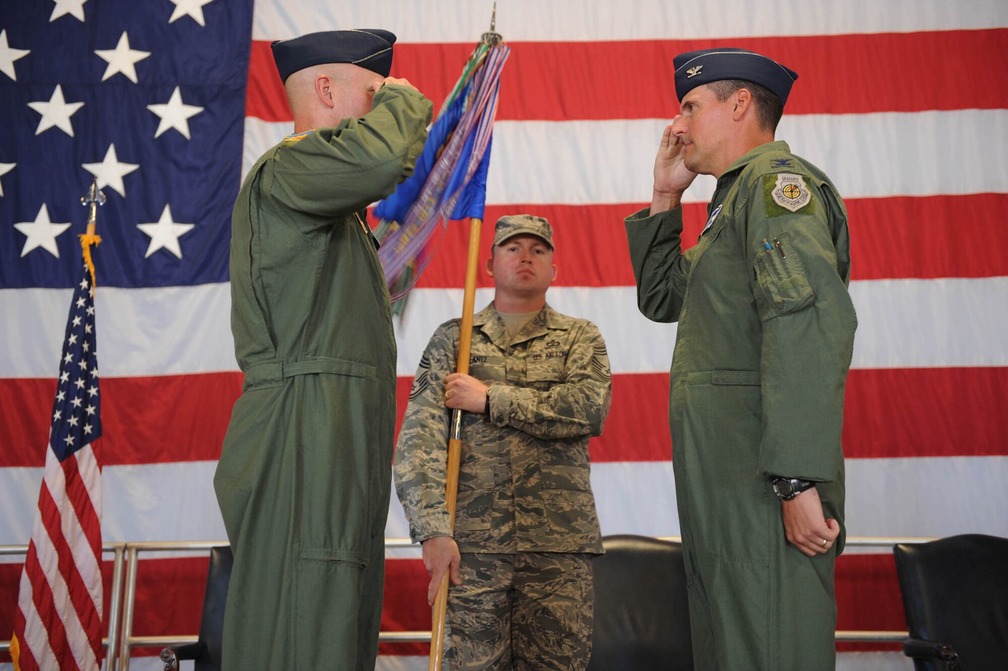 SHAW AIR FORCE BASE, S.C. -- Col. James Post, 20th Fighter Wing commander, returns a salute to Col. David Van Der Veer, 20th Operations Group commander, during the 20th OG Change of Command ceremony June 6 at Shaw. Chief Master Sgt. Steven Lantz, 20th OG interim superintendant, secures the guidon. (U.S. Air Force photo/Staff Sgt. Henry Hoegen)