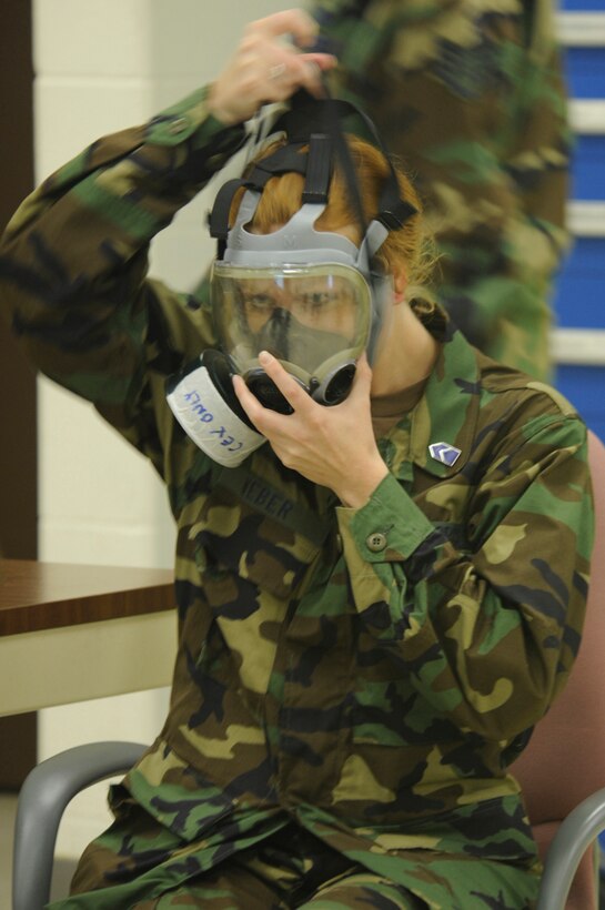 Air Force Cadet Teri Weber dons a gas mask during a chemical, biological, radiological, nuclear and high-yield explosives training course here June 5. The cadets are here from June 2 to June 20 to get hands-on exposure to the Air Force. (U.S. Air Force photo/Airman 1st Class Kasey Zickmund)