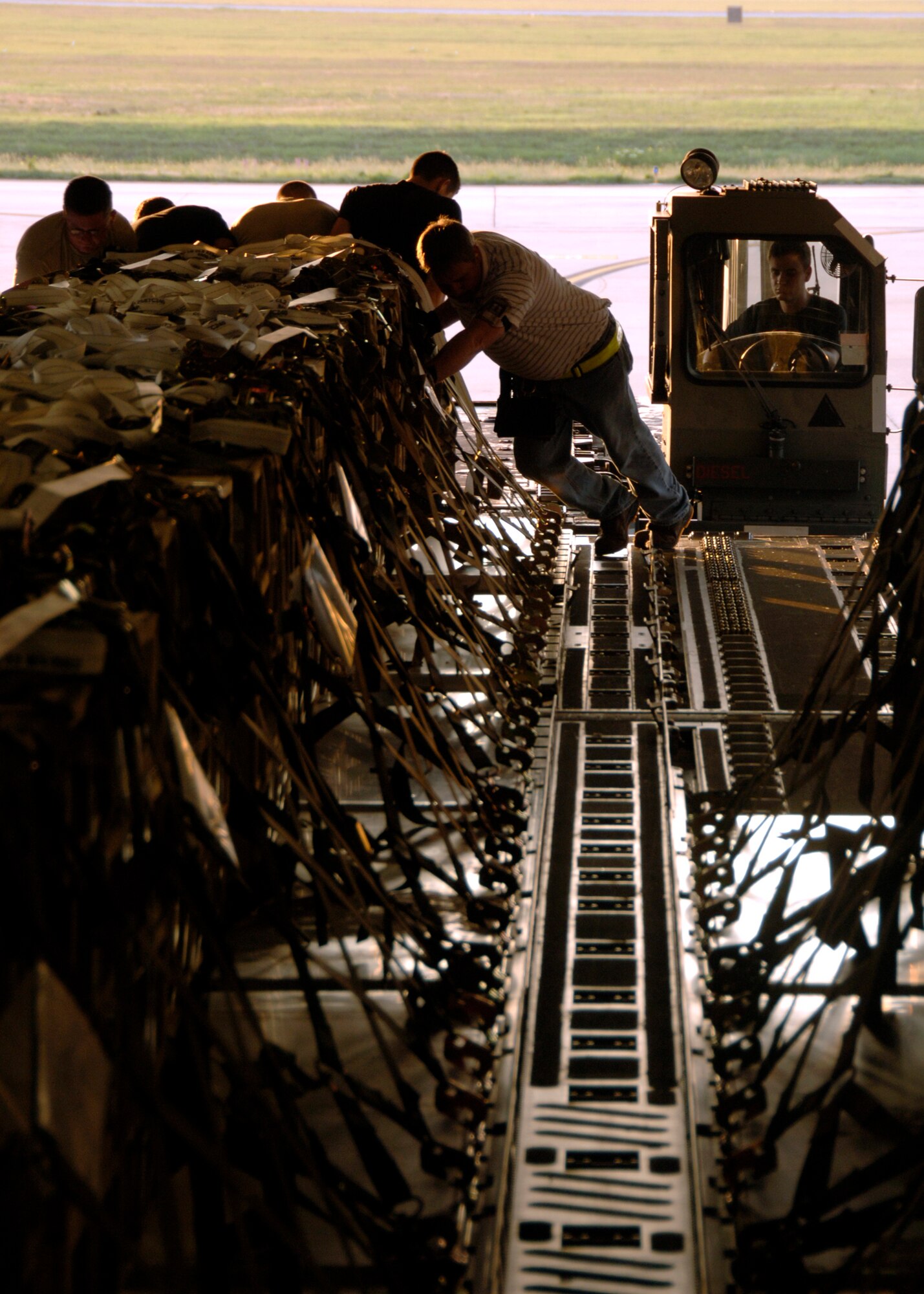 Airmen from the 437th Aerial Port Squadron load pallets of explosives from a 25K Halverson onto a C-17A Globemaster III at 7:10 a.m., 1110 ZULU, on the Charleston AFB flightline June 5. (U.S. Air Force photo/Airman 1st Class Timothy Taylor)

