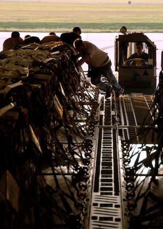 Airmen from the 437th Aerial Port Squadron load pallets of explosives from a 25K Halverson onto a C-17A Globemaster III at 7:10 a.m., 1110 ZULU, on the Charleston AFB flightline June 5. (U.S. Air Force photo/Airman 1st Class Timothy Taylor)