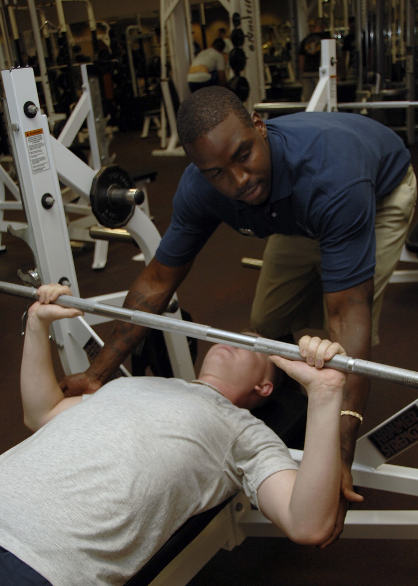 Staff Sgt. Tavarus Williams helps Airman 1st Class Christopher Freeman perform a proper bench press at 3:35 p.m., 1135 ZULU, at the fitness center on Charleston AFB June 4. Sergeant Williams is a fitness specialist with the 437th Force Support Squadron and Airman Freeman is a vehicular equipment maintainer for the 437th Logistics Readiness Squadron. (U.S. Air Force photo/Airman 1st Class Katie Gieratz)
