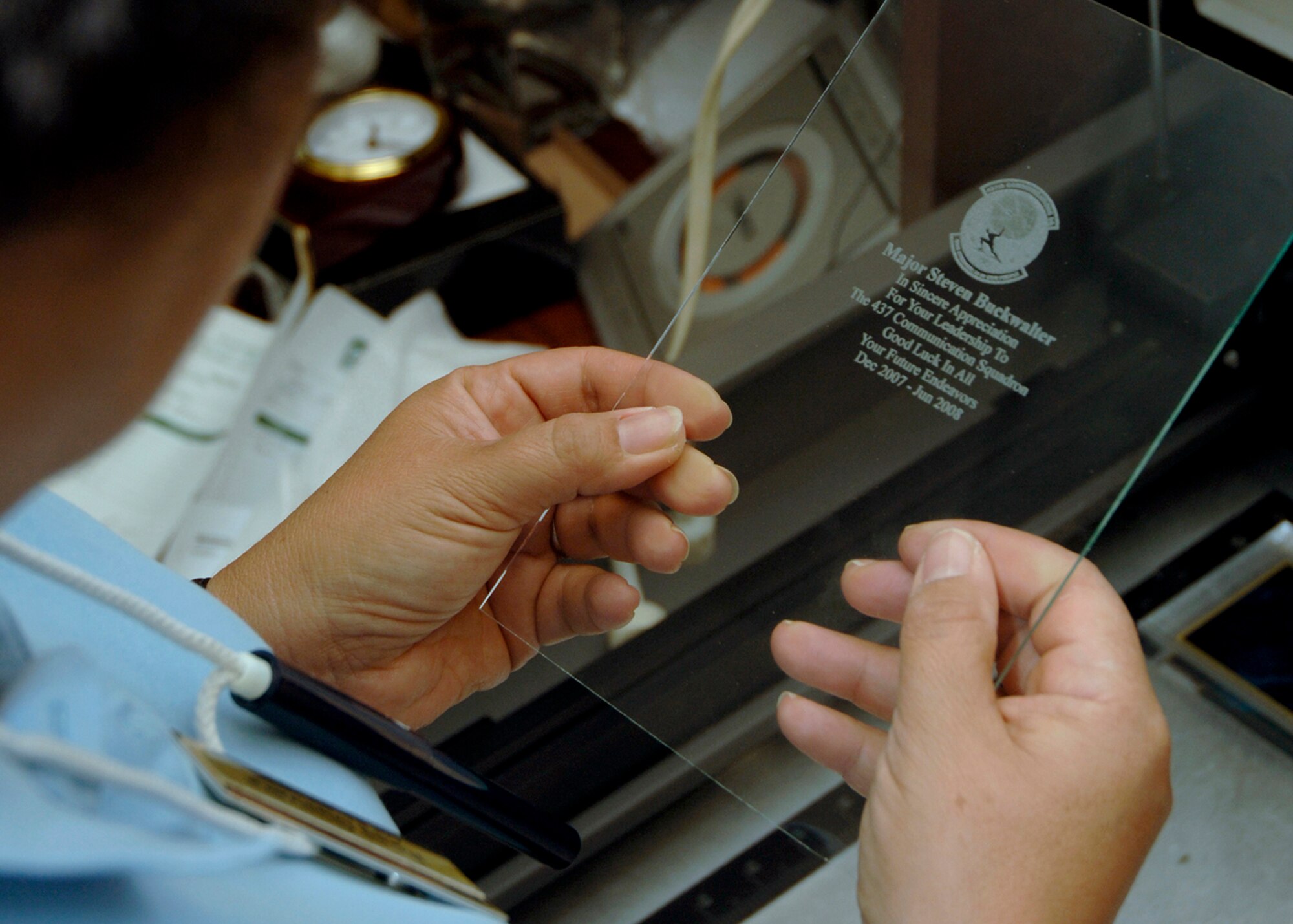 Rose Guevara inspects a laser engraved piece of glass at 11 a.m., 1500 ZULU, at the Arts and Crafts Center at Charleston AFB June 4. Mrs. Guevara is the Arts and Crafts Center's engraver, potter and assistant framer. (U.S. Air Force Photo/Airman 1st Class Timothy Taylor)
