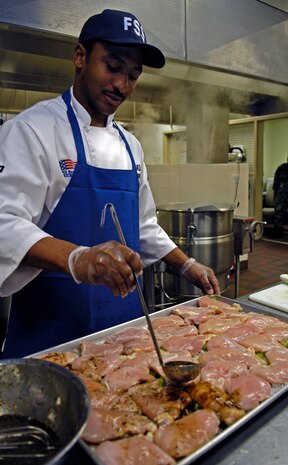 Airman 1st Class Alejandro Monroe prepares the midnight meal at the Gaylor Dining Facility on Charleston AFB June 5 at 2:48 p.m., 1848 ZULU. Airman Monroe is a chef with the 437th Force Support Squadron. (U.S. Air Force photo/Senior Airman Ali E. Flisek)