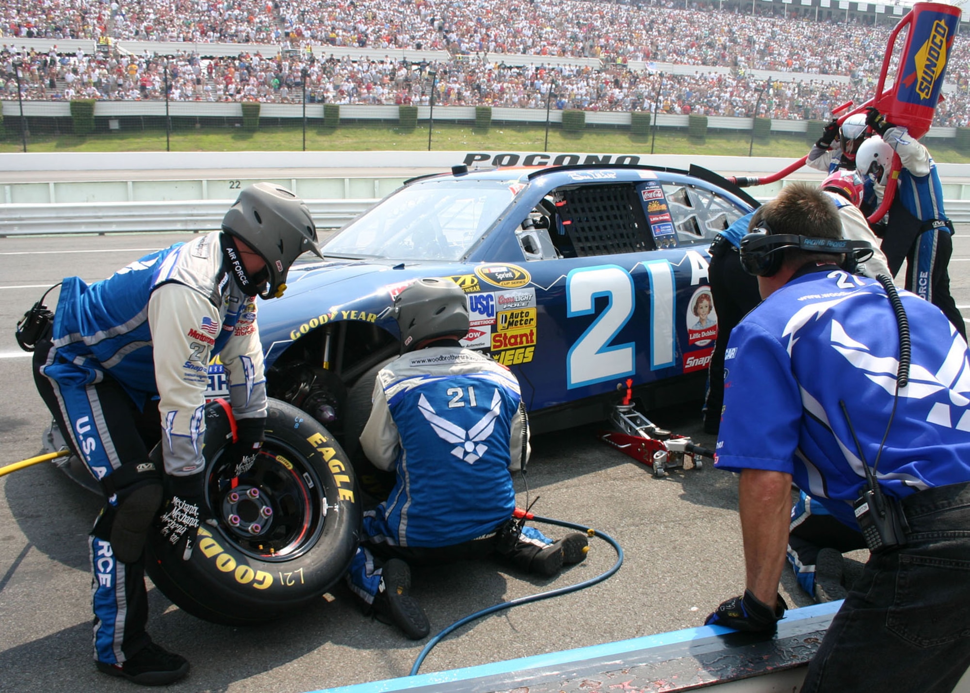 The Wood Brothers Racing pit crew completes tire changes and refuels Air Force NASCAR No. 1 with speed and precision accuracy at the Pocono 500 race June 8 in Pennsylvania. (U.S. Air Force photo/ Dale Eckroth)
