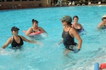 Water aerobics instructor Regina Barak (center) leads the class through various exercises at the center pool Monday. The classes are held every Monday and Wednesday in June at 10 a.m. (U.S. Air Force photo by Melissa Peterson)