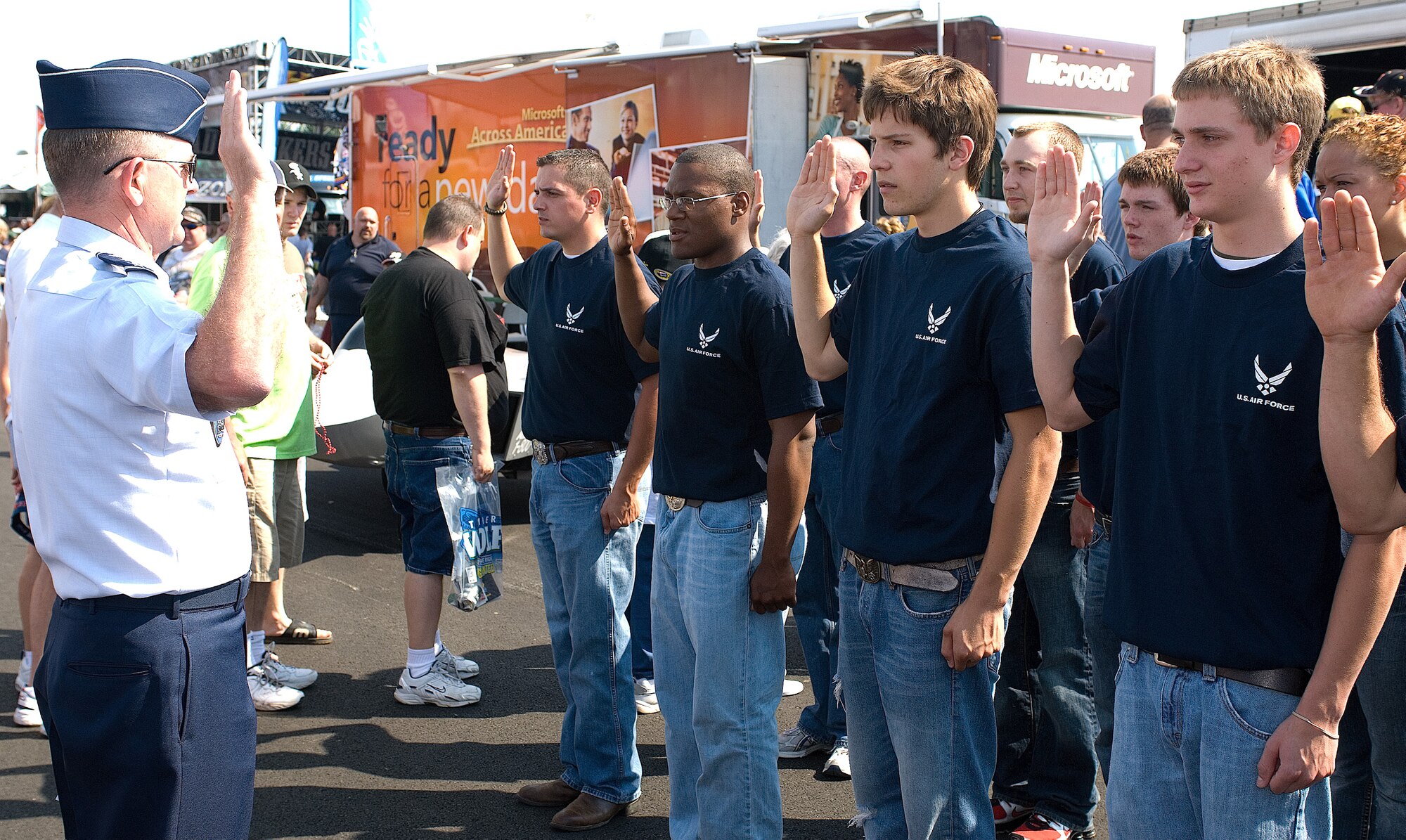 Lt. Gen. Maurice L. “Lee” McFann Jr., Allied Air Component Command Headquarters Izmir commander, swears a group of future Airmen into the delayed enlistment program at the Dover Downs International Speedway during a NASCAR event June 1.  (U.S. Air Force Photo/Roland Balik)