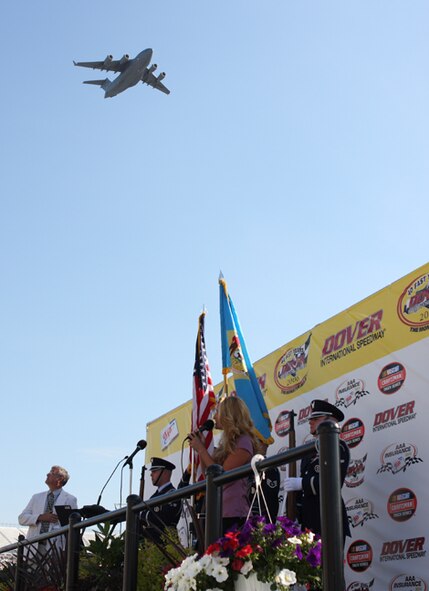 A Dover Air Force Base C-17 Globemaster III performs a flyover of the NASCAR Craftsman Series Truck Race May 30 at Dover Downs International Speedway as Lindsay Clynne finishes singing the National Anthem.  (U.S. Air Force Photo/Roland Balik)
