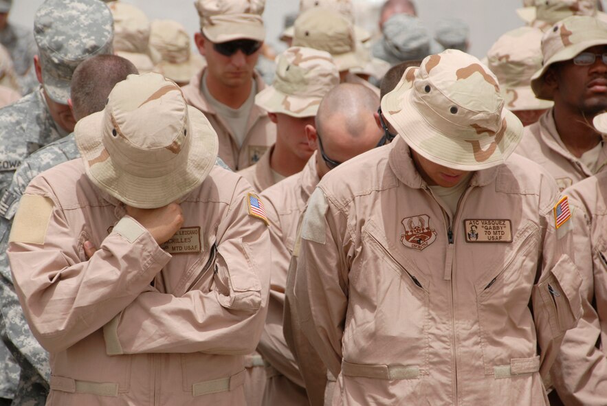 SOUTHWEST ASIA -- Airmen from the 586th Expeditionary Logistics Readiness Squadron, 70th and 424th Medium Truck Detachments, and Soldiers from the Army's 1st Theater Support Command, 640th Sustainment Brigade, 1144th Transportation Battalion, along with other Airmen from the 386th Air Expeditionary Wing, take a moment of silence during a street dedication ceremony June 10, 2008 on an air base in the Persian Gulf Region. The ceremony is a tribute to Airman 1st Class Eric Barnes and his family with the naming of Barnes Road. Airman Barnes, 20, of Lorain, Ohio, died June 10, 2007 as a result of an improved explosive device attack on an Air Force convoy about 100 miles south of Baghdad, Iraq. He was deployed from the 90th Logistics Readiness Squadron at F.E. Warren Air Force Base, Wyo.  (U.S. Air Force photo/ Staff Sgt. Patrick Dixon)