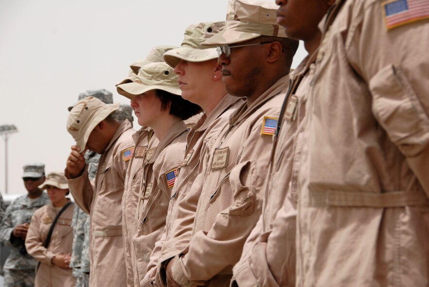 SOUTHWEST ASIA -- Airmen from the 586th Expeditionary Logistics Readiness Squadron, 70th and 424th Medium Truck Detachments, and Soldiers from the Army's 1st Theater Support Command, 640th Sustainment Brigade, 1144th Transportation Battalion, along with other Airmen from the 386th Air Expeditionary Wing, listen to a guest speaker during a street dedication ceremony June 10, 2008 on an air base in the Persian Gulf Region. The ceremony is a tribute to Airman 1st Class Eric Barnes and his family with the naming of Barnes Road. Airman Barnes, 20, of Lorain, Ohio, died June 10, 2007 as a result of an improved explosive device attack on an Air Force convoy about 100 miles south of Baghdad, Iraq. He was deployed from the 90th Logistics Readiness Squadron at F.E. Warren Air Force Base, Wyo.  (U.S. Air Force photo/ Staff Sgt. Patrick Dixon)