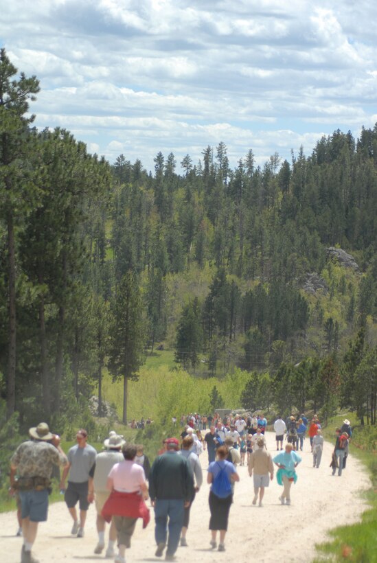 Dotted along the outstretched arm of Crazy Horse June 7 and 8 were thousands of Black Hills community members and tourists, including many from Ellsworth, who hiked to view the monument up close. The 6.2-mile trek includes dirt trails and gravel roads; it is the only time each year the public can walk to the mountain carving. (U.S. Air Force Photo/1Lt. Lauren Wright)