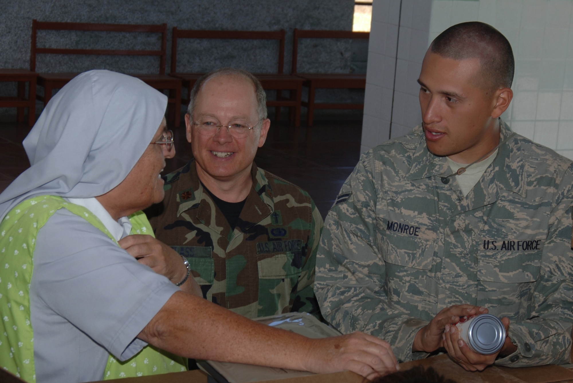 U.S. Air Force Chaplain (Maj.) James Glass (left) and Airman 1st Class George Monroe, a volunteer Spanish interpreter, both assigned to Task Force New Horizons, talk with Sister Ananda Delgado of the Juan Andres Vivanco Amorin orphanage,  after delivering food donated by the task force, June 9, in support of New Horizons - Peru 2008, a U.S. and Peru partnered effort to bring relief to underprivileged Peruvians.  (U.S. Air Force photo/Tech. Sgt. Kerry Jackson)