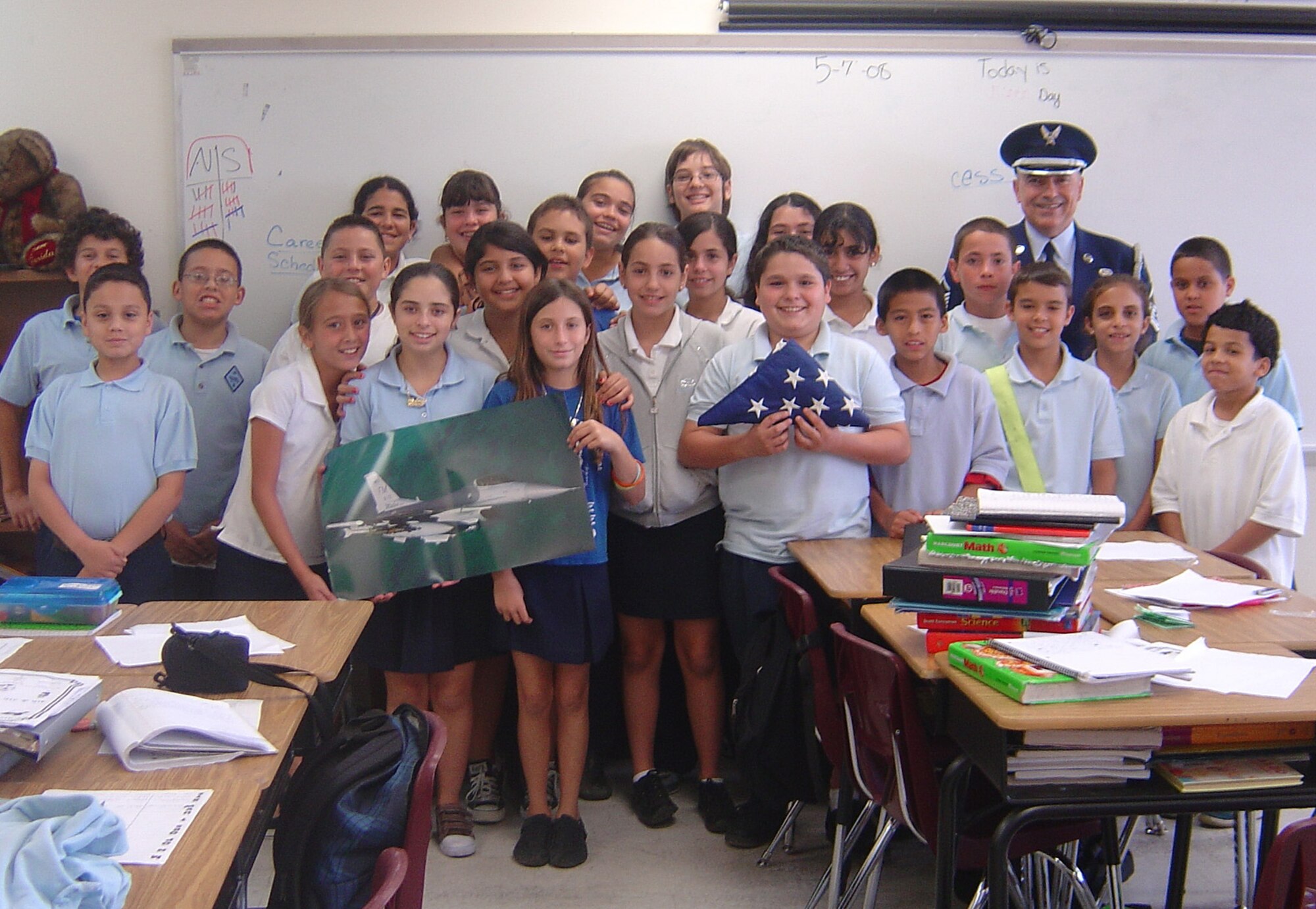 Master Sgt. Richard Rios, 482nd Communications Squadron senior air reserve technician, salutes with children from the Immaculate Conception Catholic School in Hialeah during “Career Day” in April. Each year, the City of Hialeah resident uses personal leave time to represent the Air Force Reserve during career days at public and private schools in the Hialeah area. Sergeant Rios talks about his job and the Air Force, and he explains the meaning of the American Flag. (Courtesy photo)