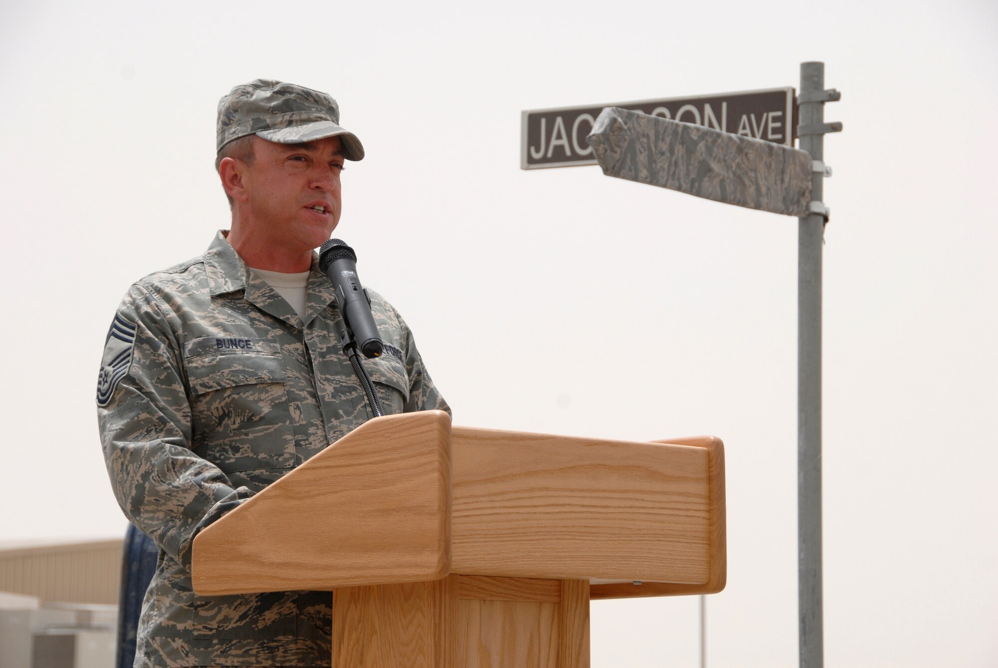 SOUTHWEST ASIA -- Chief Master Sgt. Richard Bunce, 100th Logistics Readiness Squadron chief enlisted manager, who Airman 1st Class Eric Barnes worked for at the time of his death, speaks during a street dedication ceremony June 10, 2008 on an air base in the Persian Gulf Region. The ceremony is a tribute to Airman Barnes and his family with the naming of Barnes Road. Airman Barnes, 20, of Lorain, Ohio, died June 10, 2007 as a result of an improved explosive device attack on an Air Force convoy about 100 miles south of Baghdad, Iraq. He was deployed from the 90th Logistics Readiness Squadron at F.E. Warren Air Force Base, Wyo.  (U.S. Air Force photo/ Staff Sgt. Patrick Dixon)