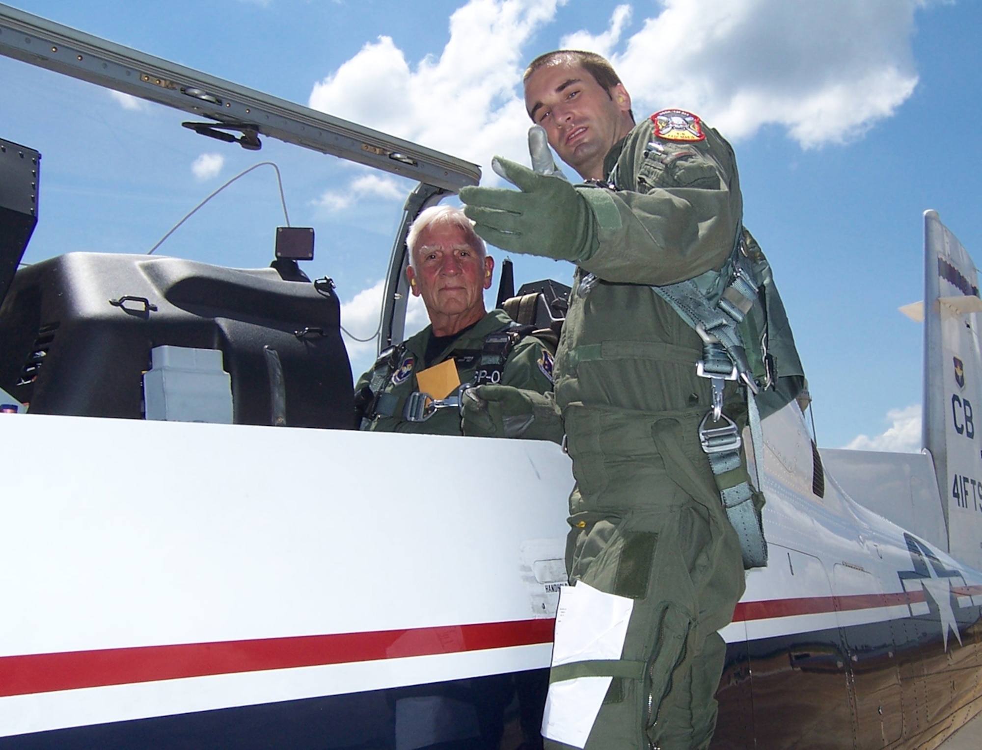 Captain Josh Higgins, 41st Flying Training Squadron Instructor Pilot, briefs Col. Carlyle "Smitty" Harris before his T-6 flight June 6. Colonel Harris was the keynote speaker for the graduation for Specialized Undergraduate Pilot Training class 08-10. (U.S. Air Force photo by Sonic Johnson)