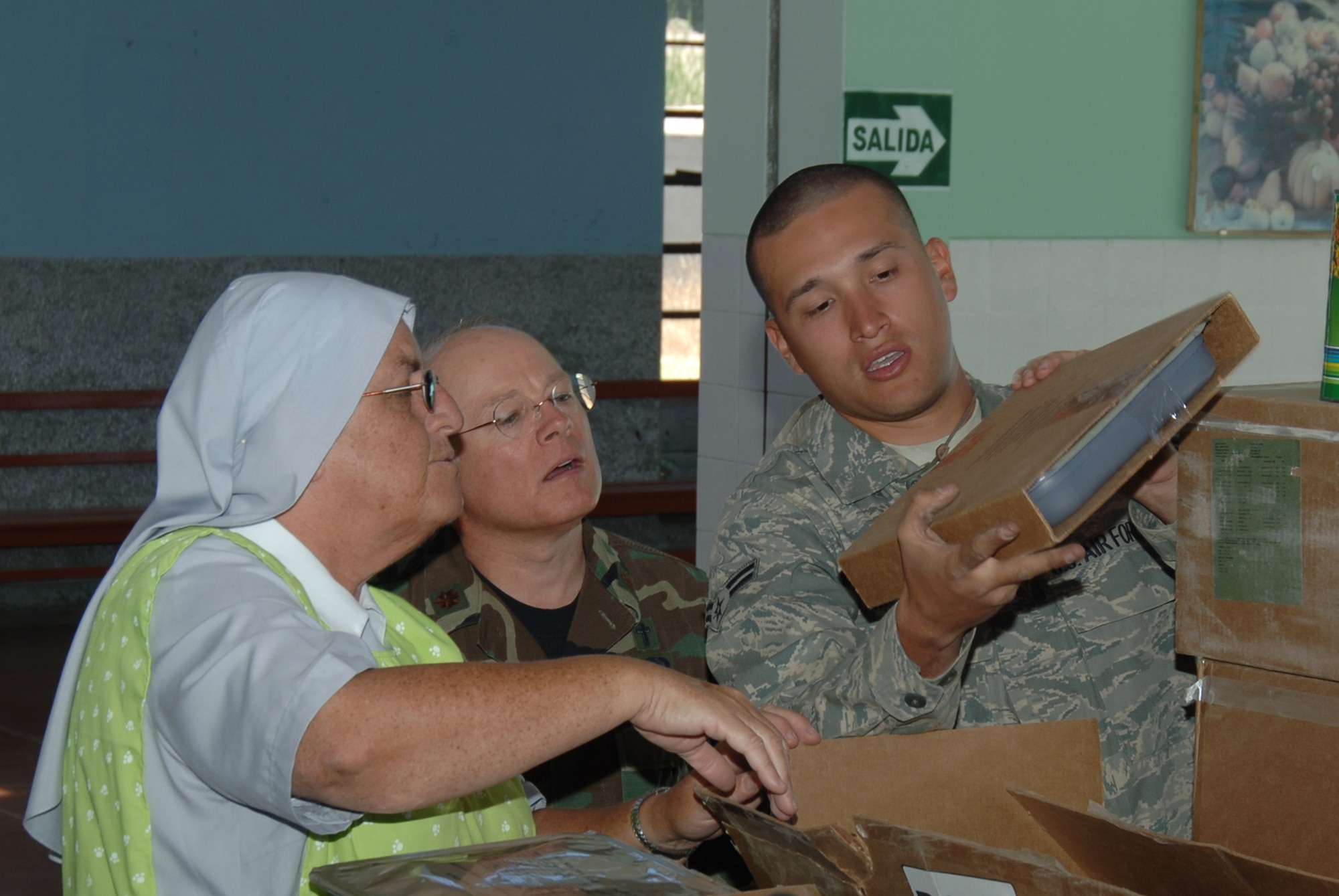 U.S. Air Force Airman 1st Class George Monroe, assigned to Tinker Air Force Base, Okla., offers his bilingual talents to describe the contents of food packages donated by Task Force New Horizons Peru, June 9, in support of New Horizons - Peru 2008, a U.S. and Peru partnered effort to bring relief to underprivileged Peruvians. (U.S. Air Force photo/Tech. Sgt. Kerry Jackson)