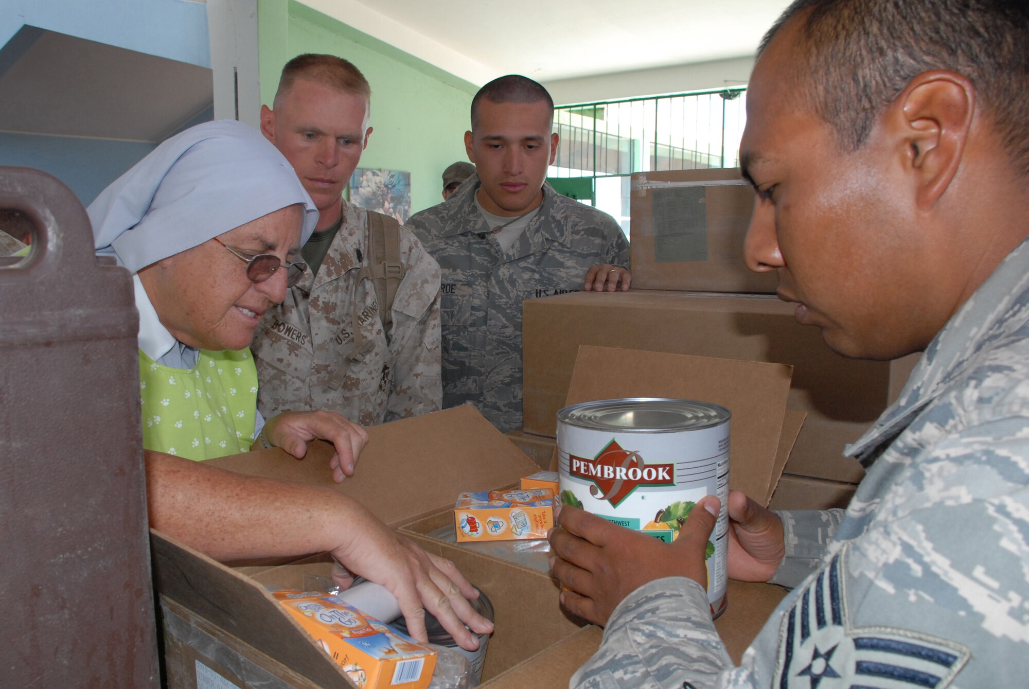 Staff Sgt. Javier Romero, deployed from the 820th Rapid Engineer Deployable Heavy Operation Repair Squadron Engineer (RED HORSE) Squadron at Nellis Air Force Base, Nev., helps Sister Amanda Delgado explore a box of food donated by the U.S. military, June 9, to Juan Andres Vivanco Amorin, a children’s orphanage in Ayacucho, Peru. The orphanage houses 180 boys and girls who will be affected by the support given to New Horizons Peru 2008, a Peruvian and U.S. partnered effort to build schools, clinics, and wells for the Peruvian people. (U.S. Air Force photo/Airman 1st Class Tracie Forte)