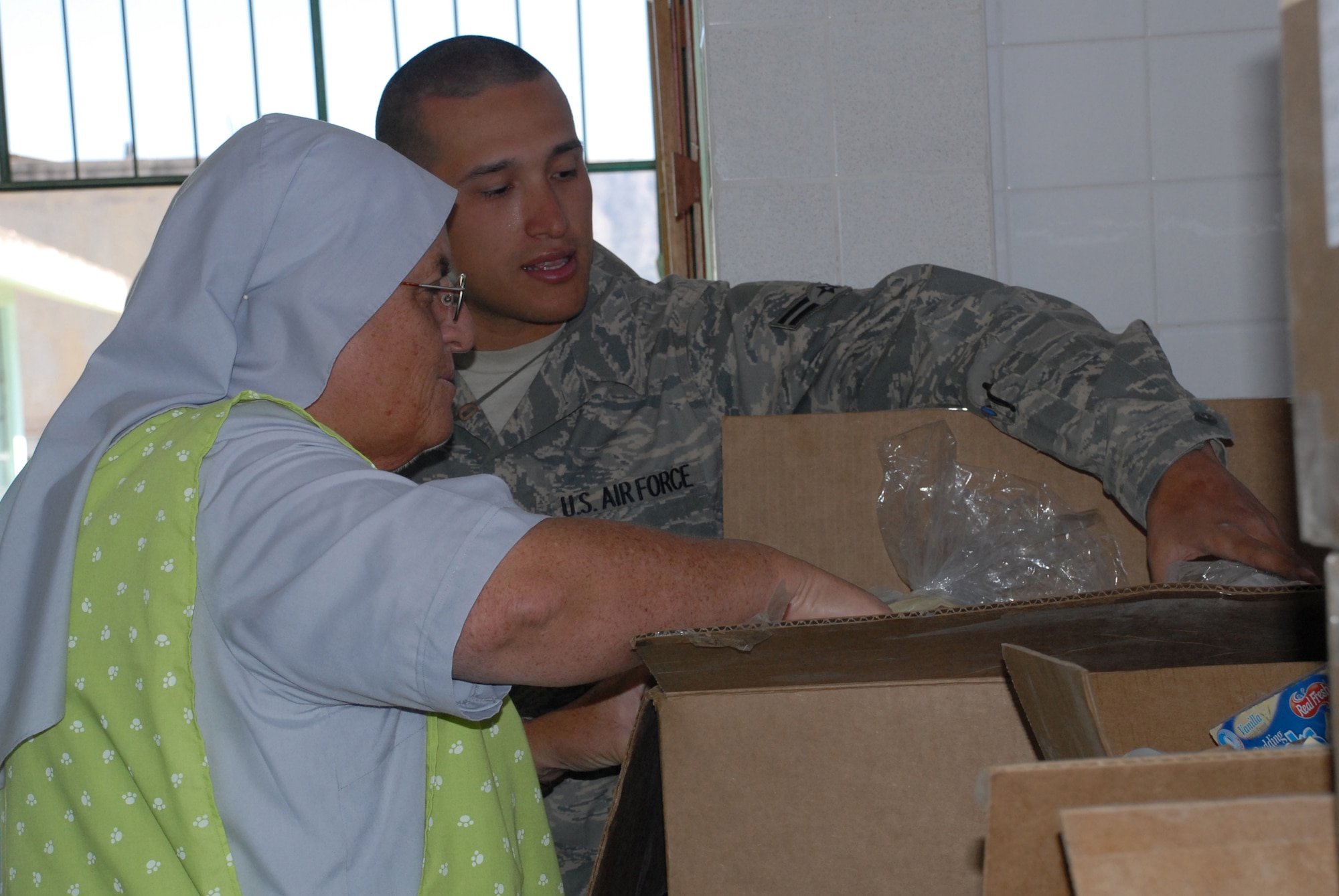 Airman 1st Class George Monroe, deployed from Tinker Air Force Base, Okla., shows Sister Amanda Delgado the types of food donated by U.S. servicemembers, June 9, to Juan Andres Vivanco Amorin, a children’s orphanage in Ayacucho, Peru. The orphanage houses 180 boys and girls who will be affected by the support given to New Horizons Peru 2008, a Peruvian and U.S. partnered effort to build schools, clinics, and wells for the Peruvian people. (U.S. Air Force photo/Airman 1st Class Tracie Forte)