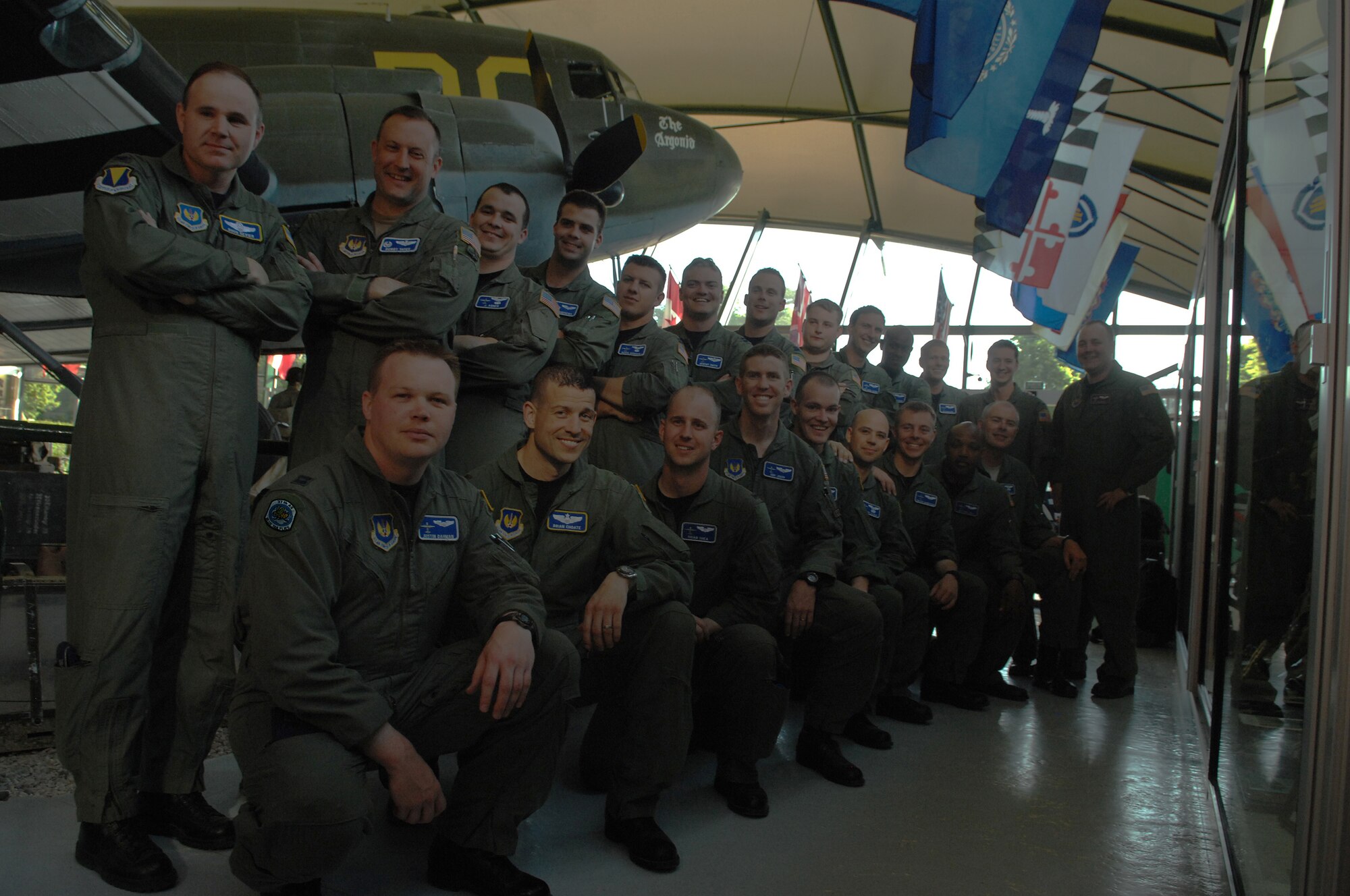 Members of the 37th Airlift Squadron pose for a group photo in front of a WWII C-47 Skytrain in the Airborne troops museum, Sainte-Mere-Eglise, France, June 7.  The 37th AS did fly-bys over towns, ceremonies, and flew paratroopers for D-Day commemorations. Photo by Airman 1st Class Amber Bressler