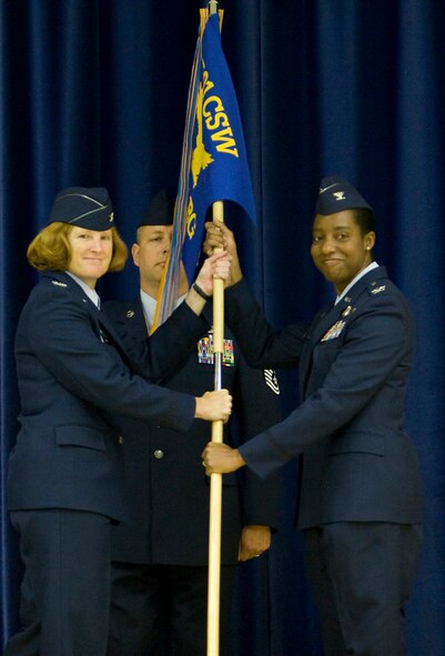 Col. Kimberly Toney, 501st Combat Support Wing commander passes the 422nd Air Base Group flag to Col. Sharon Holmes signifying Col. Holmes assumption of command over the unit on June 2.The ceremony was attended by base military personnel, DoD civilians, State Department personnel, MOD civilians, base family members and local community leaders as well as visiting military members from throughout the United Kingdom.
