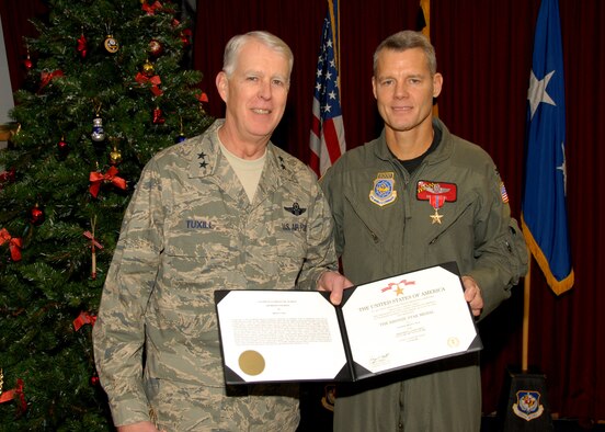 Maj. Gen. Bruce F. Tuxill presents the Bronze Star to Col. Brian Neal (U.S. Air Force Photo by Master Sgt. Ed Bard)