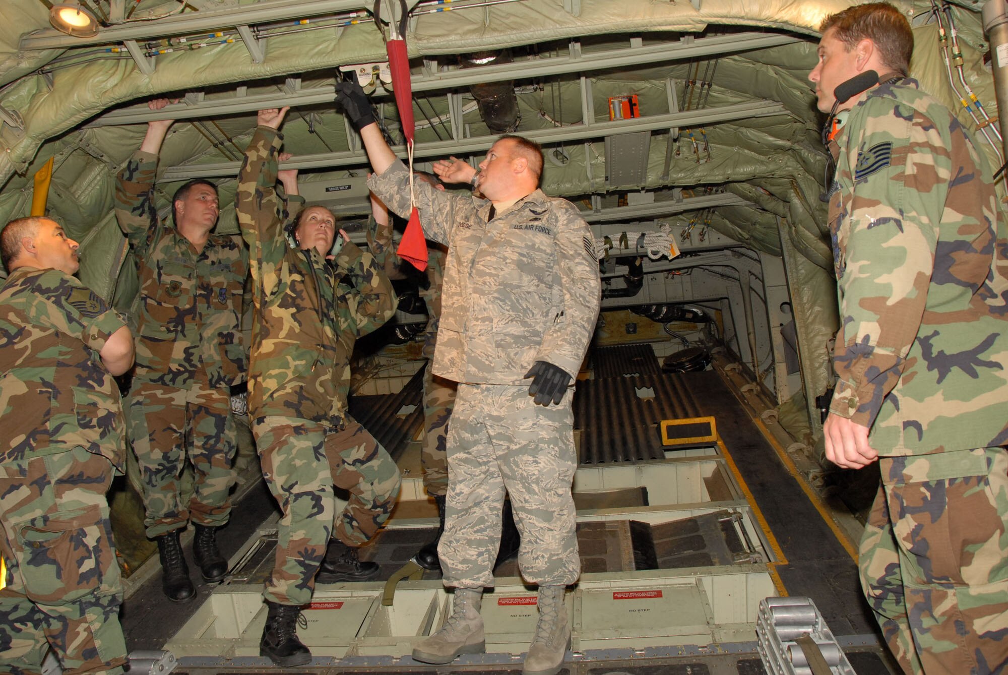 Tech. Sgt. Tim Dodge of the AETC Field Training Team explains the cargo door operation. Members of the 107th Maintenance Squadron perform field training on the C-130H2 aircraft at the Niagara Falls Reserve Station . Standing behind the instuctor from left to right, Master Sgt. Carl Azzarelli, Master Sgt. William Davis, Master Sgt. Nancy Traxler and Tech. Sgt. Mark Traxler looks on from the right. The 107th is converting from the KC-135R to the C-130H2.(US Air Force Photo/ Senior Master Sgt Raymond Lloyd)
