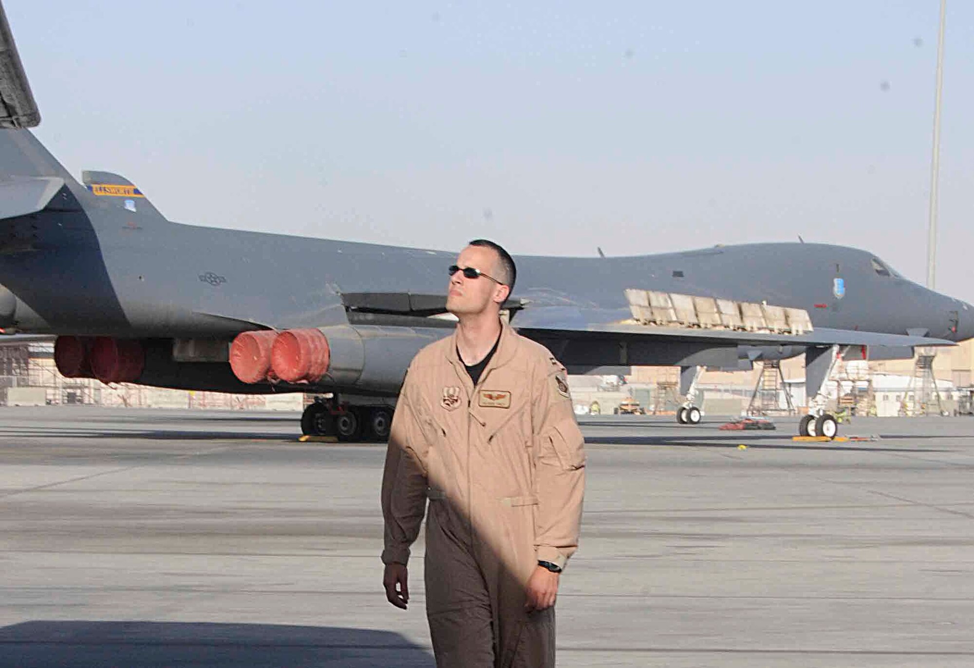 SOUTHWEST ASIA -- Capt. Patrick Sines, 37th Expeditionary Bomb Squadron weapons systems officer, does a pre-flight check along the driver's-side wing of a B-1 here June 5. A pilot and weapons system officer walk around the aircraft to check for loose cables, dent and scrapes, fuel leaks and other discrepancies to ensure the overall integrit of the jet.