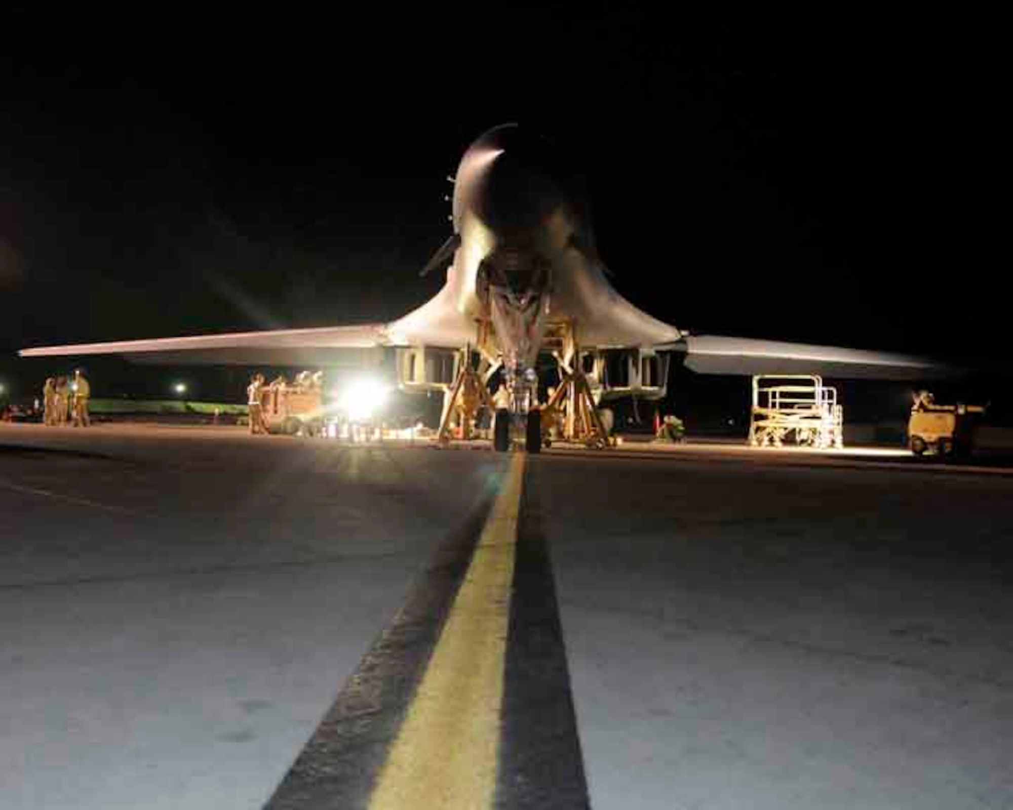 SOUTHWEST ASIA—A B-1 bomber is jacked and ready for repairs by the 37th Aircraft Maintenance Unit maintainers May 29. The maintainers use industrial lights to illuminate their workspace during the night hours. (U.S. Air Force photo/ Senior Airman Domonique Simmons)  
