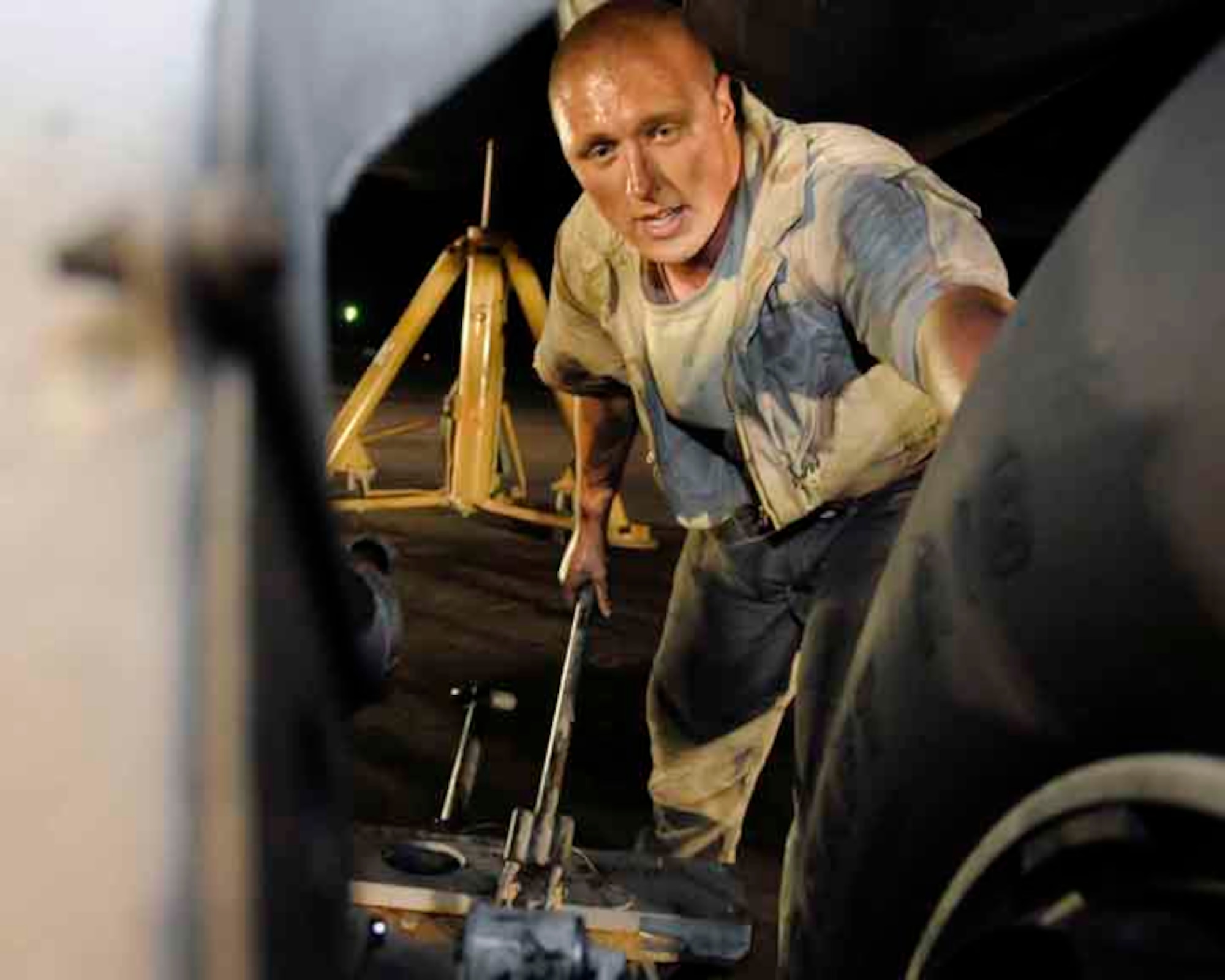 SOUTHWEST ASIA—Staff Sgt. David Nygaard, 37th Aircraft Maintenance Unit B-1 crew chief, jacks the Lancer's landing gear to change the brakes and tires May 29. Sergeant Nygaard is deployed from Ellsworth Air Force Base, S.D. “At night, you can see the afterburners of the B-1s that are taking off. After a good, long day of work, it makes you feel like you made a difference in the world ... and you’re glad you’re not the Taliban,” he said. (U.S. Air Force photo/ Senior Airman Domonique Simmons)