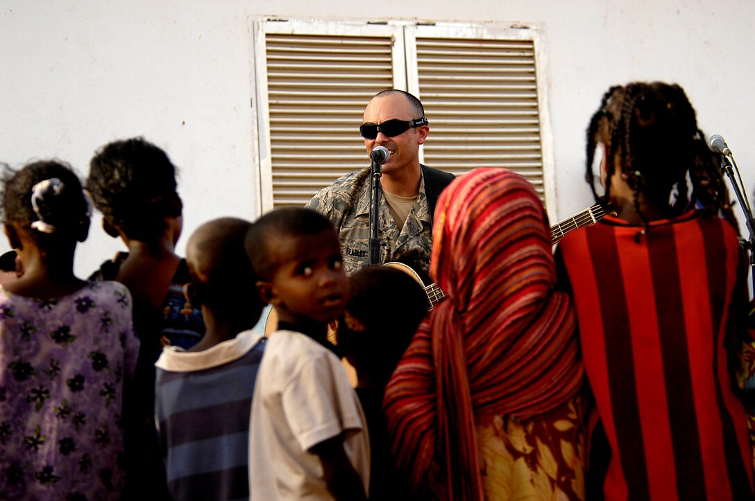 U.S. Air Force Senior Airman John D. Beasley, a bass player with the Air Force Central Command Band, Falcon, performs with the band in Negad, Djibouti, May 22, 2008.