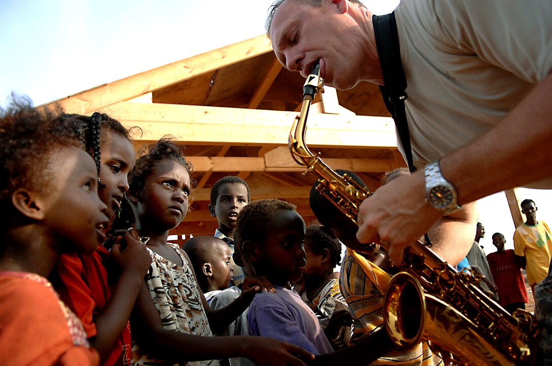 U.S. Air Force Master Sgt. Daniel Weber performs for villagers in Negad, Djibouti, May 22, 2008. The band is deployed to support Combined Joint Task Force - Horn of Africa out of Camp Lemonier, Djibouti. Weber is a saxophone and vocalist with the U.S. Air Force Central Command Band, Falcon.