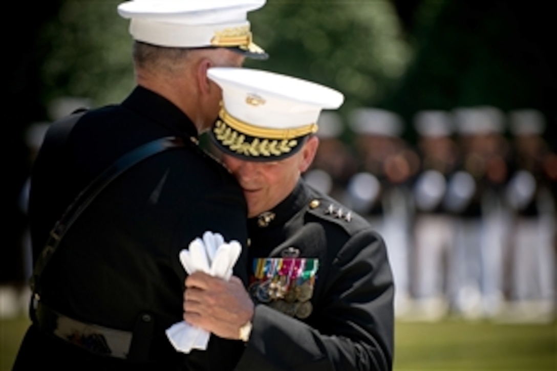U.S. Marine Lt. Gen. John Sattler, right, director for strategic plans and policy for the Joint Staff, is embraced by key note speaker Gen. Jim Conway, commandant, U.S. Marine Corps, during Sattler's retirement ceremony at the Marine Barracks, Washington, D.C., June 9, 2008. Sattler retired after more than 35 years of active duty in command positions throughout the world. 