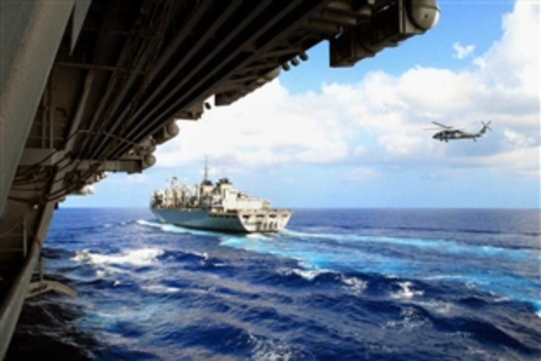 The Military Sealift Command fleet replenishment oiler USNS Bridge pulls along side the aircraft carrier USS Ronald Reagan before a replenishment, Pacific Ocean, June 7, 2008. The USS Ronald Reagan Carrier Strike Group is on a scheduled deployment in the 7th Fleet area of responsibility operating in the western Pacific and Indian ocean. 