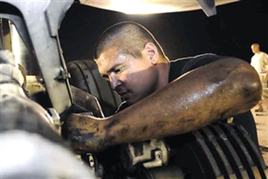 U.S. Air Force Staff Sgt. Kendall Lizama gets greased up while repairing brake parts on a B-1B Lancer in  Southwest Asia, May 29, 2008. Lizama is assigned to the 37th Aircraft Maintenance Unit. 