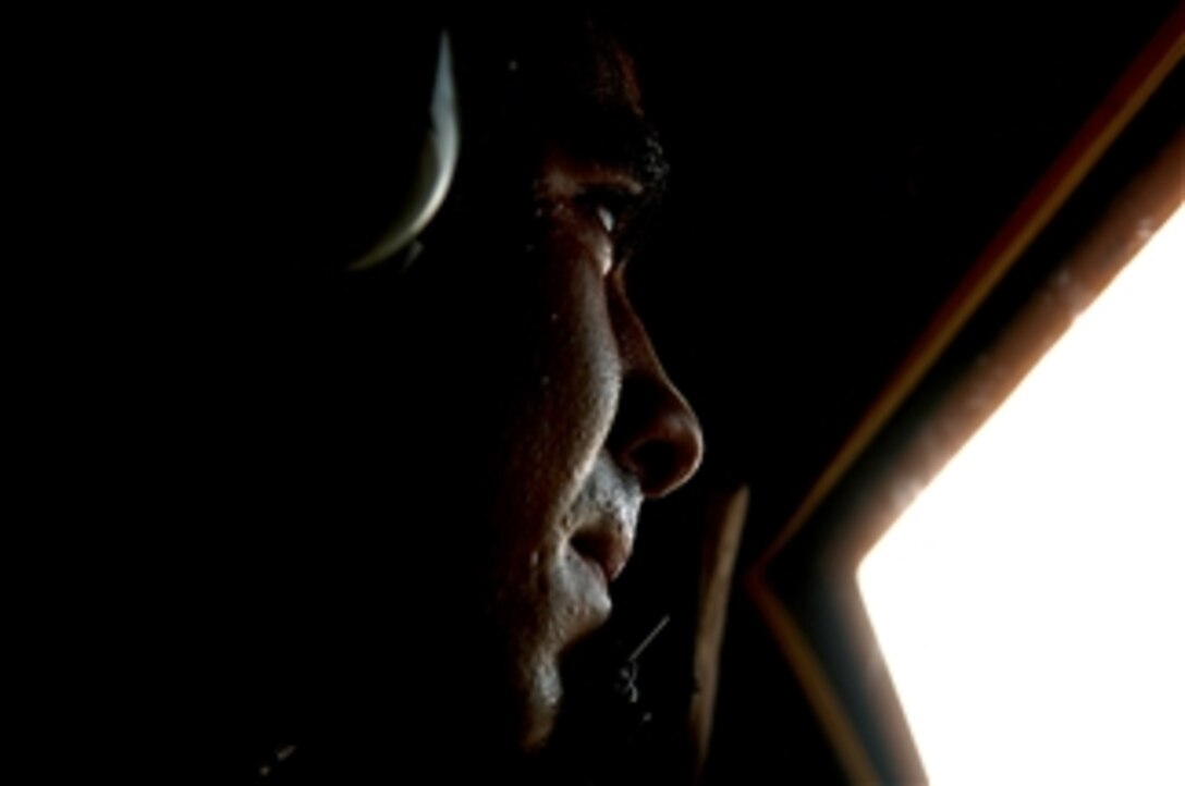 U.S. Air Force Airman 1st Class Nicholas Greer, an HC-130 Combat King aircraft loadmaster from the 71st Search and Rescue Squadron out of Moody Air Force Base, Ga., scans the skies through the jump door window during a mission off the coast of Djibouti on June 3, 2008.  Greer is deployed to Combined Joint Task Force - Horn of Africa out of Camp Lemonier, Djibouti.  