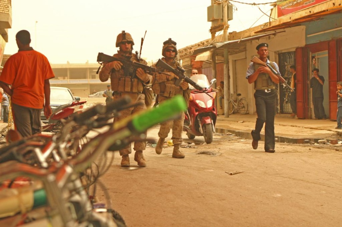RAMADI, Iraq (June 10, 2008) - A group of Marines and Iraqi Policemen conduct a foot patrol in the souk, a bustling market area in the heart of Ramadi June 9. This patrol would’ve been out of the question nearly two years ago, when the market and Ramadi were at the forefront of the insurgency. The market area was widely considered by most as a “no go” zone. Within seconds of entering the area, Marines would often encounter small-arms and sniper fire, along with rocket-propelled grenade attacks. But, since then, the locals have revolted against the insurgency and have embraced the presence of Coalition forces, in turn beginning the rebuilding of the bullet-riddled city. (Official U.S. Marine Corps by Lance Cpl. Casey Jones) (RELEASED)