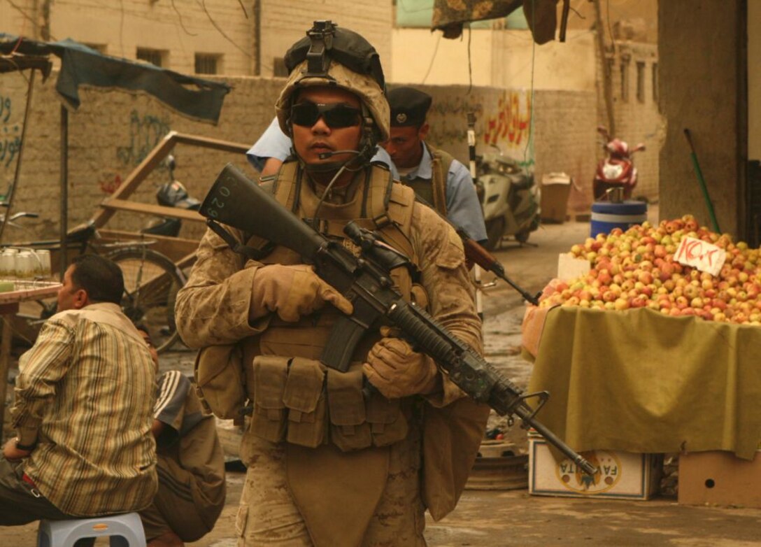 RAMADI, Iraq (June 11, 2008) - Petty Officer 2nd Class Giovanni Lozano, hospitalman with 1st Battalion, 9th Marine Regiment, Regimental Combat Team 1, patrols through the market area of Ramadi, locally known as the souk June 9. This patrol would’ve been out of the question nearly two years ago, when the market and Ramadi were at the forefront of the insurgency. The city’s market area was widely considered by most as a “no go” zone. Within seconds of entering the area, Marines would often encounter small-arms and sniper fire, along with rocket-propelled grenade attacks. But, since then, the locals have revolted against the insurgency and have embraced the presence of Coalition forces, in turn beginning the rebuilding of the bullet-riddled city. (Official U.S. Marine Corps by Lance Cpl. Casey Jones) (RELEASED)
