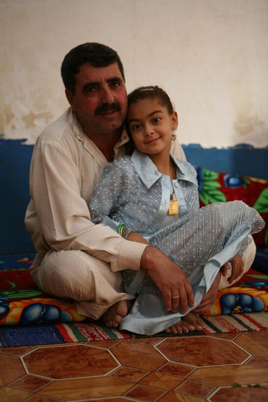 Basima Zalaan, 7, sits with her father, Zalaan Mohsin Rafea, during a visit from Marines with 3rd Battalion, 4th Marine Regiment, Regimental Combat Team 5, at Zalaanâ??s home in Haditha, Iraq, June 12. Basima was the third child in the area to travel out of Iraq to receive surgery to correct a congenital heart defect. Basimaâ??s case was different from the other two because instead of traveling to the United States, she flew to Jordan for the surgery. Basima is recovering well and hopes to someday be a doctor.