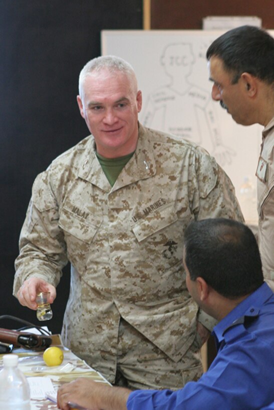 Col. Patrick Malay, commanding officer, Regimental Combat Team 5, uses an empty glass of chai tea to compare the similarities of making chai tea and operating a Joint Communication Center during a JCC course at Camp Ripper, Iraq, June 10.  Malay explained that the tea or water by themselves do not make chai tea, its only when all the ingredients are mixed together that a cup of chai tea is made.  Similarly, a JCC is only functional when all the parts work together.  Iraqi Security Force personnel attended the two-day course so that they can go back to their districts and teach JCC operations to their fellow ISF personnel.