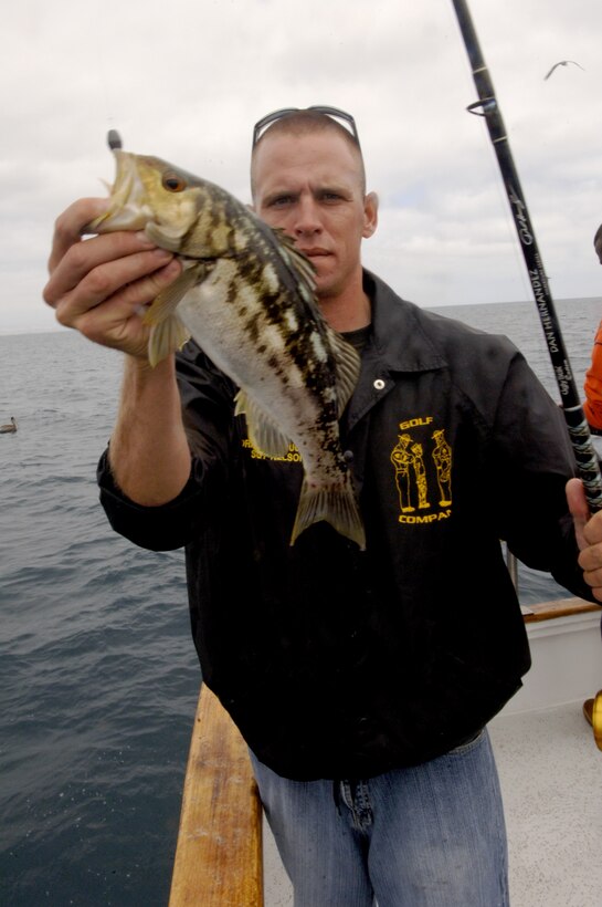 Sgt. Jon Nelson, drill instructor, Company G, displays his biggest fish, a calico bass that he caught in the Coronado Islands, June 11. In total, the Marines caught more than 200 fish in 12 hours. ::r::::n::::r::::n::