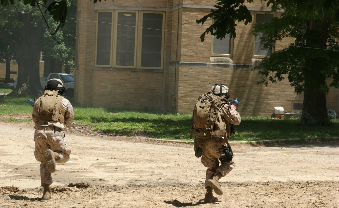 Marine from the Battalion Landing Team 2/6, 26th Marine Expeditionary Unit, assault a building at the Muscatatuck Urban Training Center, June 11, 2008, in Butlerville, Ind.  The 26th MEU was in Indiana to complete the Realistic Urban Training exercise, part of its predeployment training period, and a precursor to its upcoming deployment, scheduled for late August, 2008.  (Official USMC photo by Cpl. Aaron J. Rock)  (Released)::r::::n::