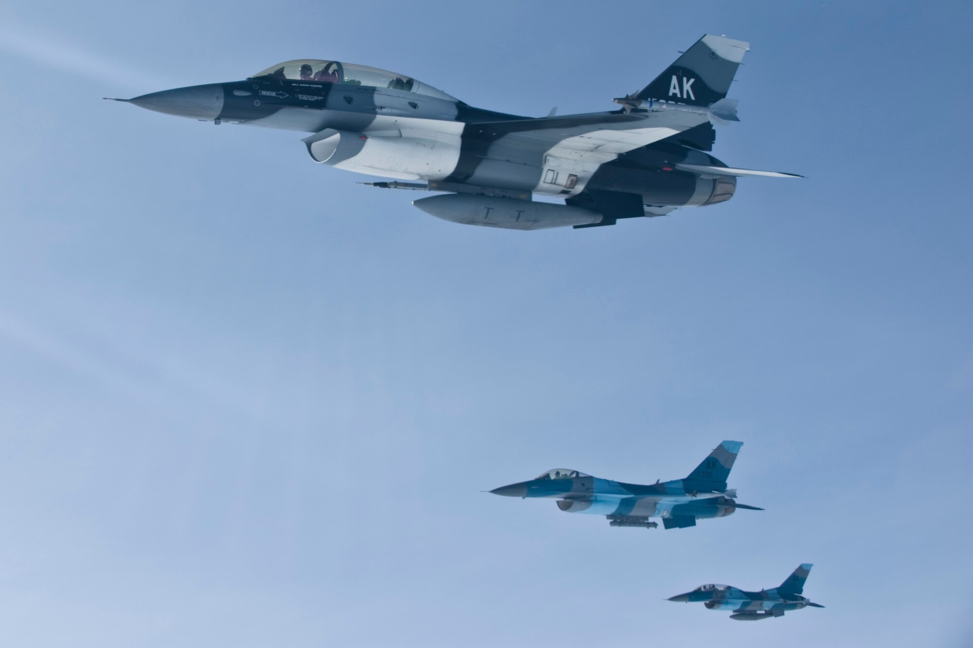 Three F-16 Aggressors fly in formation after being refueled June 10, 2008, at Eielson Air Force Base, Alaska during RED FLAG-Alaska 08-3. The Pacific Alaskan Range Complex provides 67,000 square miles of airspace, one conventional bombing range and two tactical bombing ranges containing more than 400 different types of targets and more than 30 threat simulators, both manned and unmanned. These aircraft are assigned to the 18th Aggressor Squadron. (U.S. Air Force Photo/Airman 1st Class Jonathan Snyder)