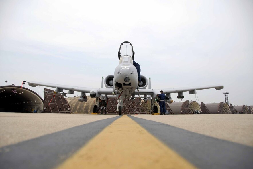 OSAN AIR BASE, Republic of Korea -- Capt. Jason Shemchuk, an 25th Fighter Squadron A-10 pilot, Senior Airman Joshua Bowyer and Airman 1st Class Jeffrey Douglas, 51st Aircraft Maintenance Squadron A-10 crew chiefs, perform and aircraft inspection before a sortie June 11. Both the pilots and crew chiefs play a vital role in ensuring the plane has been properly inspected and is safe to fly. (U.S. Air Force photo/Senior Airman Christopher Boitz)