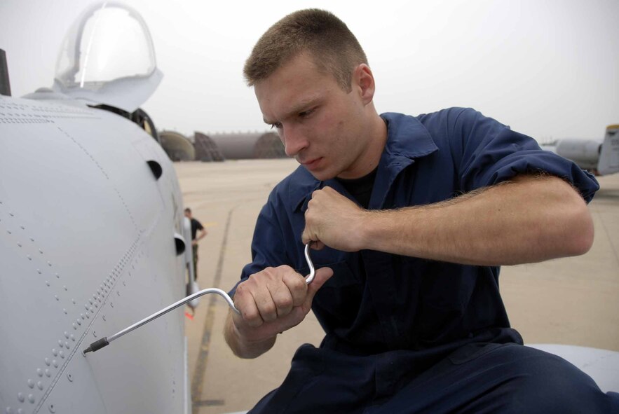 OSAN AIR BASE, Republic of Korea – Airman 1st Class Jeffrey Douglas, 51st Aircraft Maintenance Squadron A-10 crew chief, tightens a tridair during a routine maintenance check June 11. The tridair holds the panels in place on the A-10. As a crew chief, Airman Douglas is responsible for making sure the aircraft is safe and ready to fly. (U.S. Air Force photo/Senior Airman Christopher Boitz)
