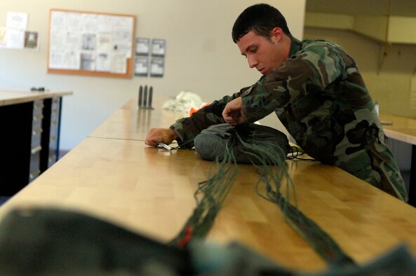 BARKSDALE AIR FORCE BASE, La. - Airman Jesse Conley of 2d Operational Support Squadron repacks a parachute, June 11.
Members of Life Support and Survival Equipment recently merged to form one unit called Aircrew Flight Equipment. (U.S. Air Force photo by Airman 1st Class Joanna M. Kresge)