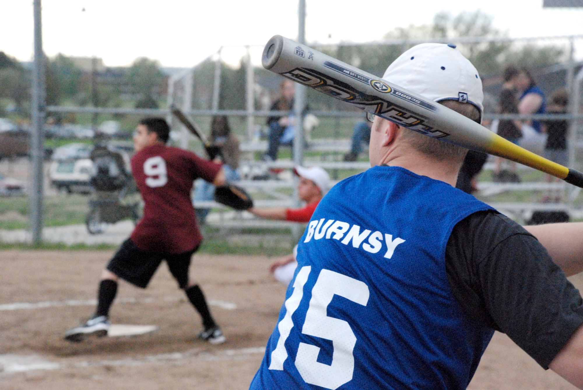 Airman 1st Class Vincent Hernandez, 90th Maintenance Group team, prepares to hit the ball as teammate Airman 1st Class Jake Burns practices his swing before his turn.