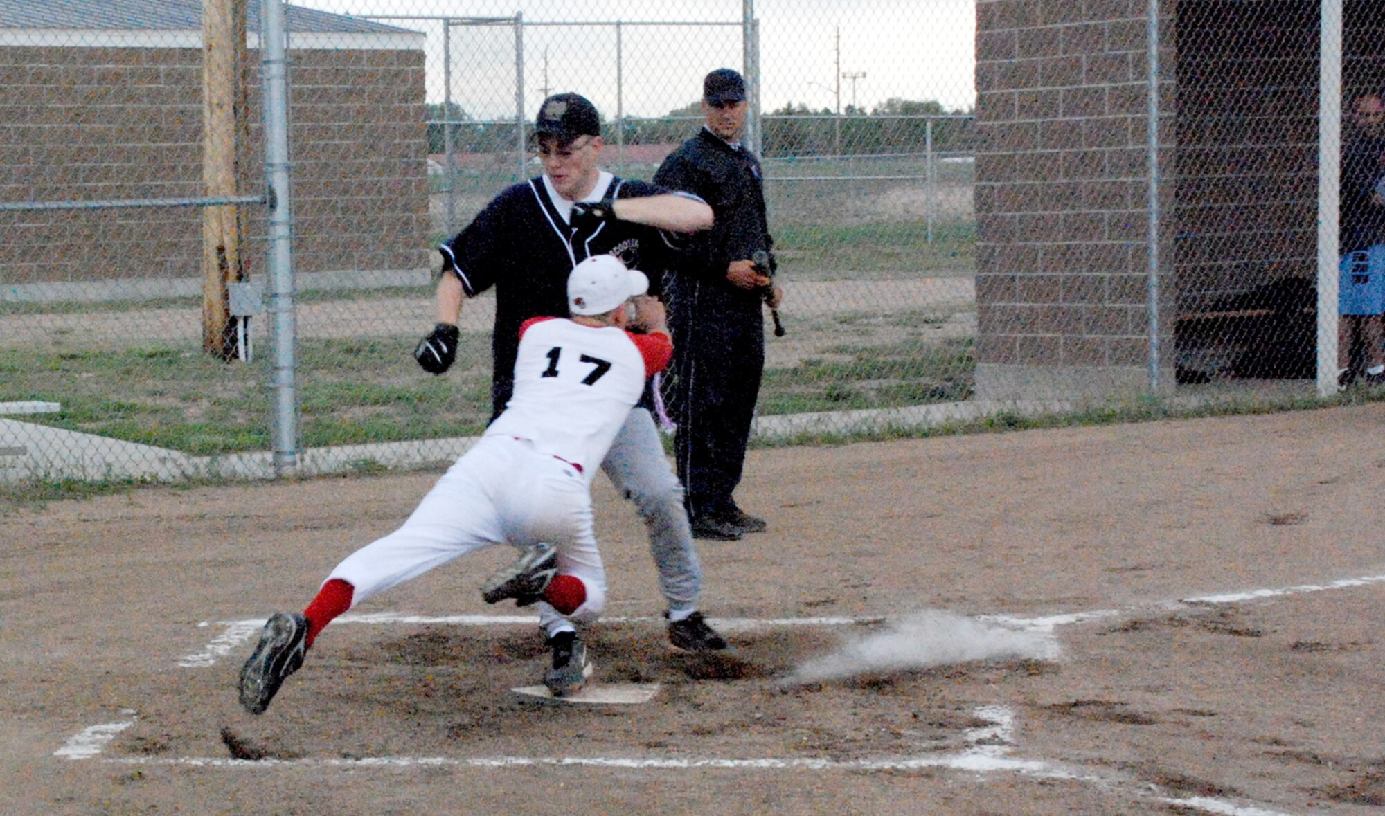 Airman 1st Class Thomas Collucci, 790th Missile Security Forces Squadron team, tries to tag the runner out at home plate during the softball game (Photos by Airman 1st Class Daryl Knee).