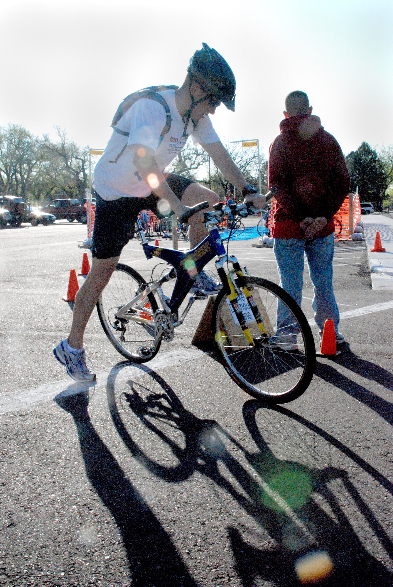 Spencer Johnson, Wyoming National Guard, boards his bike after swimming 500 yards in the aquatic center. Contestants then had to run to the parking lot across the street where their bikes were waiting in racks.