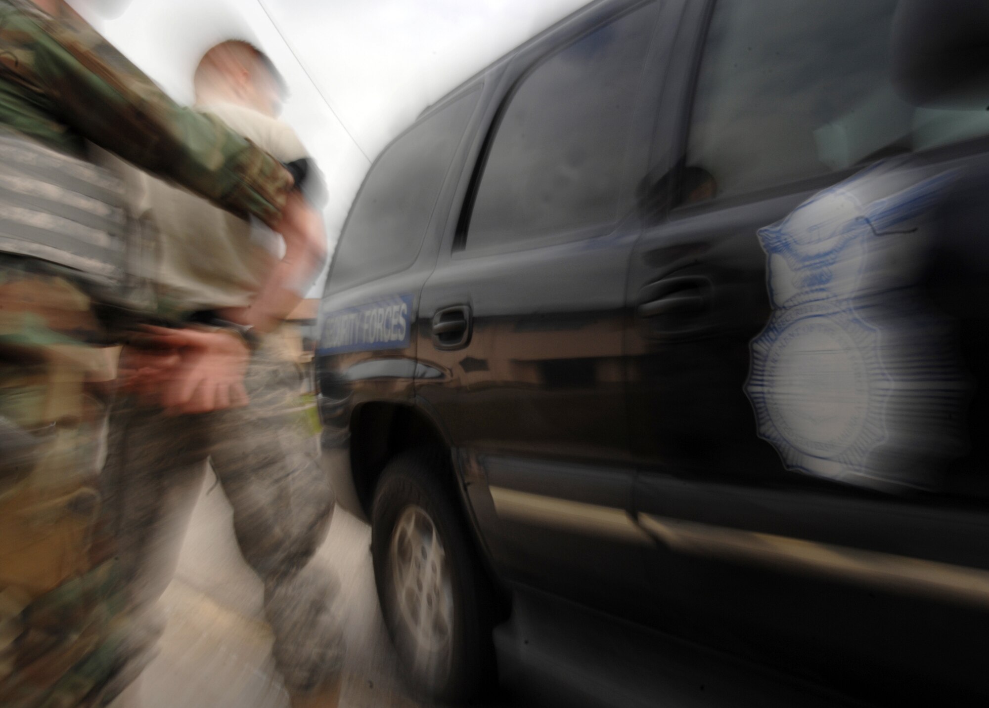 Air Force Security Forces Special Emergency Response Team member escorts Staff Sgt. Dean Martinez toward a security forces vehicle during a counter-terrorism exercise at Eielson Air Force Base, June 9, 2008.  This training exercise is used for security forces personnel to remain current on the policies and procedures involving hostage retrieval, barricaded subjects, and counter-terrorism. SERT is the Air Force security forces equivalent to civilian police forces SWAT team. (U.S Air Force photo/Tech Sgt Eric T. Sheler)